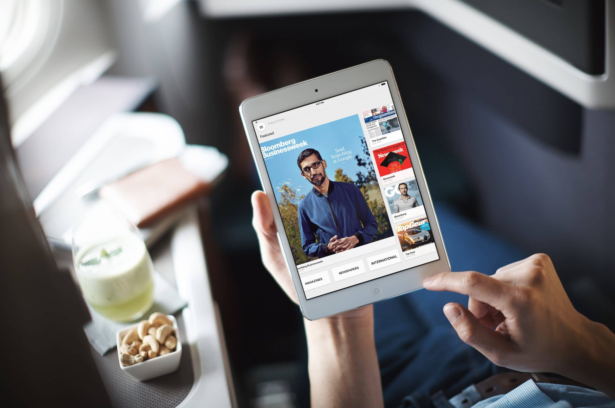 A Cathay Pacific passenger using PressReader on their iPad. Image via PressReader